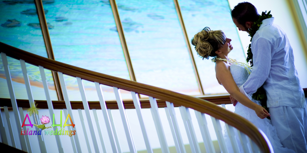 Bride and groom on the estate house staircase beneath a skylight